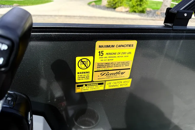 Slide: The Image of Warning label on 2026 Bentley Pontoons Legacy 220 Cruise XL, detailing capacity and safety instructions. - 17