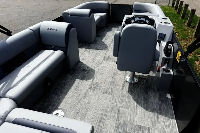 Slide: The Image of 2026 Bentley Pontoons Legacy 220 Cruise XL interior with gray seating and modern dashboard. - 21