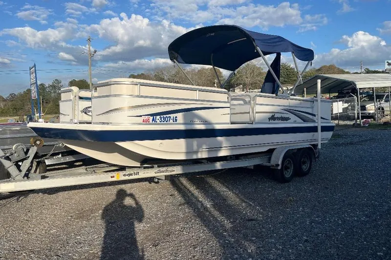 Slide: The Image of 2005 Hurricane FunDeck 226 boat on trailer under blue sky. - 10