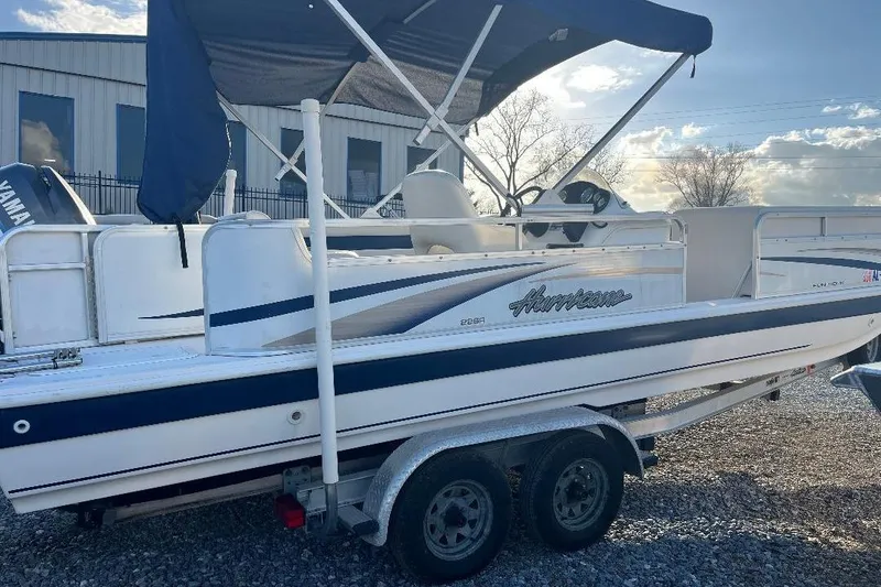 Slide: The Image of 2005 Hurricane FunDeck 226 boat on trailer with canopy, parked outdoors. - 6