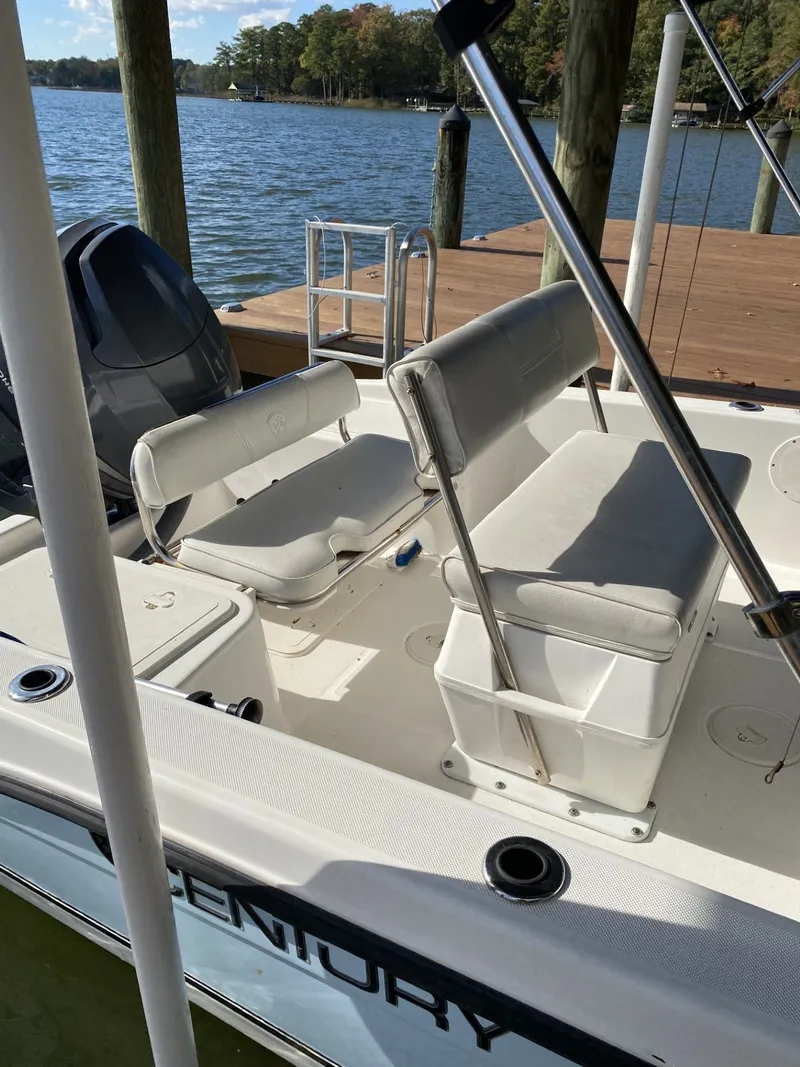 Slide: The Image of 2006 Century 17 CC boat at dock with seating benches. - 2