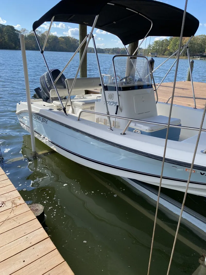 Slide: The Image of 2006 Century 17 CC boat docked on calm water. - 3