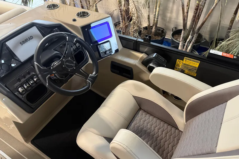 Slide: The Image of 2026 Bentley Pontoons Elite 223 Admiral helm with steering wheel and navigation display. - 9
