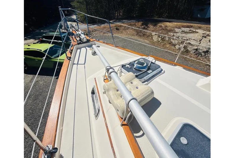 Slide: The Image of Deck view of a 1995 Island Packet 37 sailboat, surrounded by trees. - 20