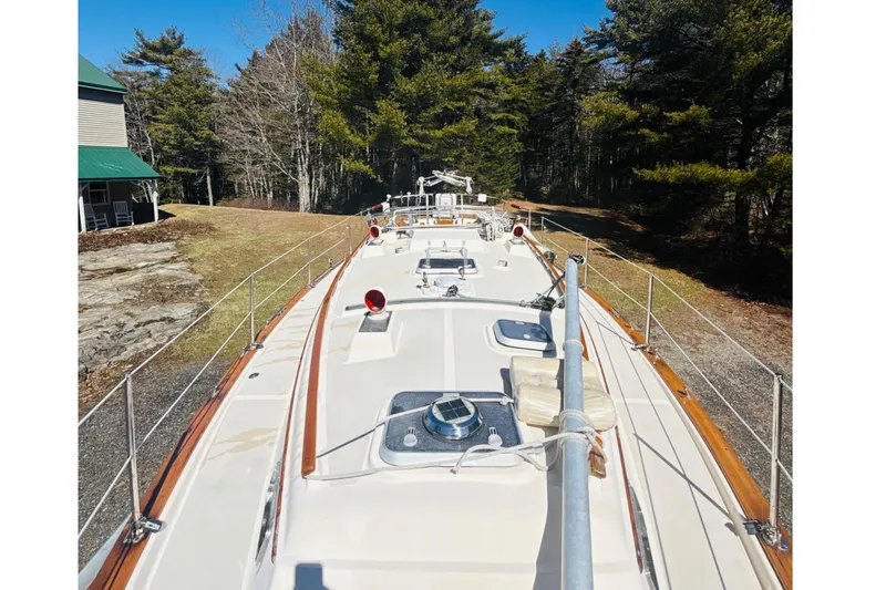 Slide: The Image of 1995 Island Packet 37 sailboat deck with forest backdrop. - 22