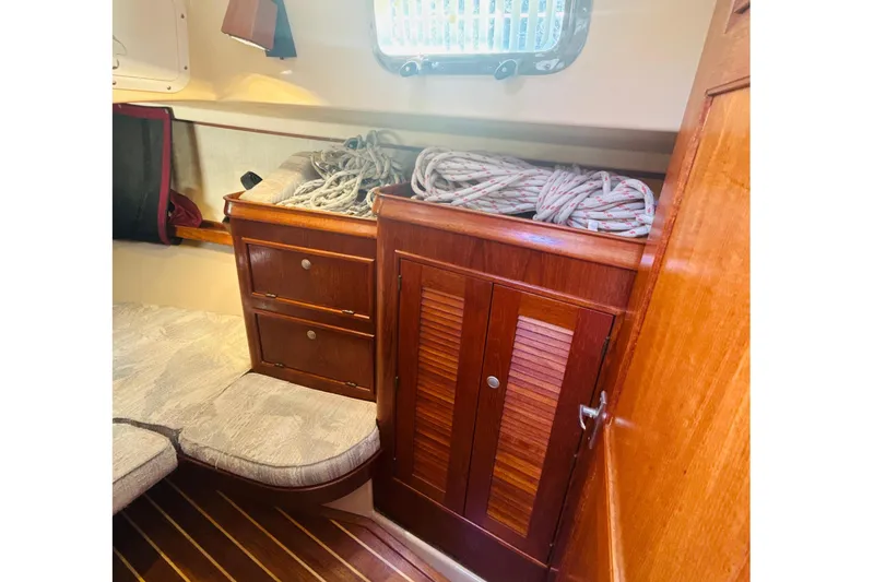Slide: The Image of 1995 Island Packet 37 sailboat cockpit with open companionway and wooden trim. - 26
