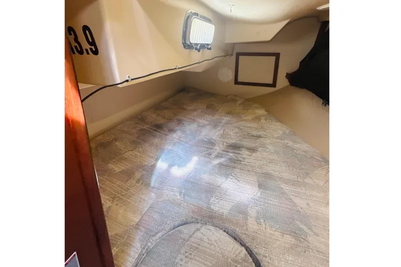 Slide: The Image of Interior of a 1995 Island Packet 37 sailboat with wooden cabinetry and cozy seating. - 28