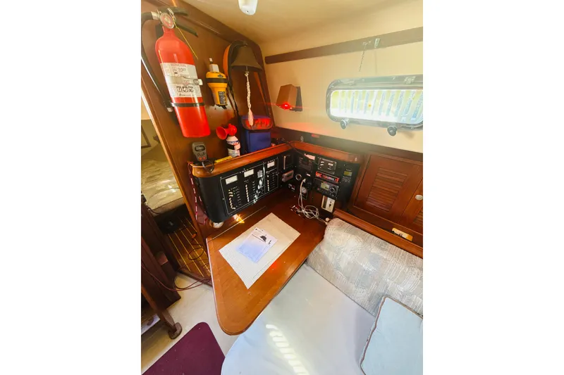 Slide: The Image of Interior view of 1995 Island Packet 37 sailboat, featuring wooden cabinetry and cozy seating. - 31