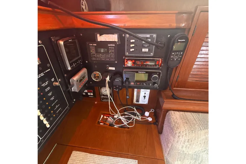 Slide: The Image of Interior of 1995 Island Packet 37 sailboat with wooden flooring and cozy seating area. - 32