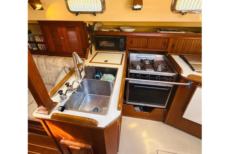Slide: The Image of Interior of 1995 Island Packet 37 sailboat with cozy seating and wooden finishes. - 35