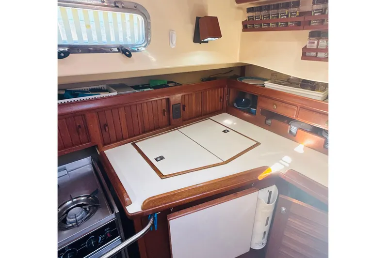 Slide: The Image of Interior of 1995 Island Packet 37 sailboat with cozy seating and kitchenette. - 36