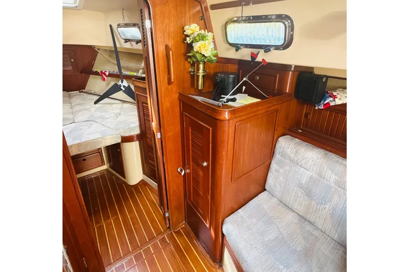 Slide: The Image of Interior of 1995 Island Packet 37 sailboat galley with wooden cabinetry and spice rack. - 40