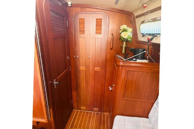 Slide: The Image of Interior of 1995 Island Packet 37 sailboat with cozy seating and wooden finishes. - 41