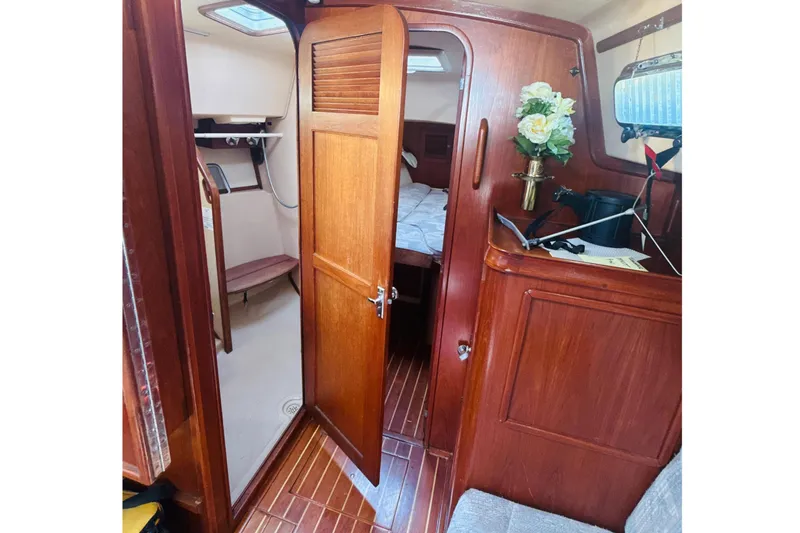 Slide: The Image of Interior of 1995 Island Packet 37 sailboat with wood finish and cozy seating area. - 42