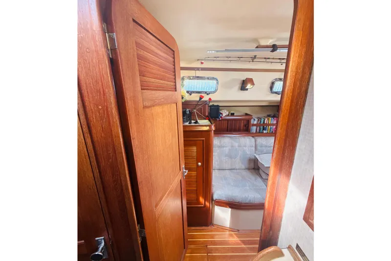 Slide: The Image of 1995 Island Packet 37 yacht bathroom with sink, toilet, and wooden accents. - 46