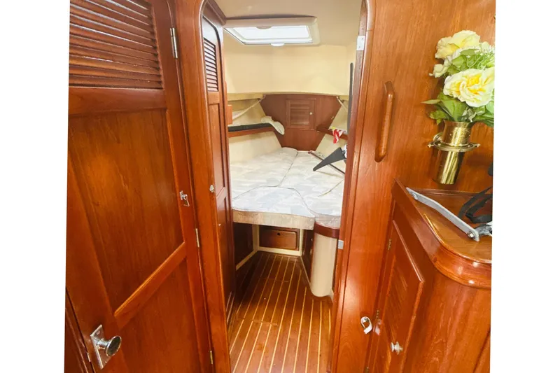 Slide: The Image of 1995 Island Packet 37 sailboat bathroom with shower, toilet, and wooden accents. - 47