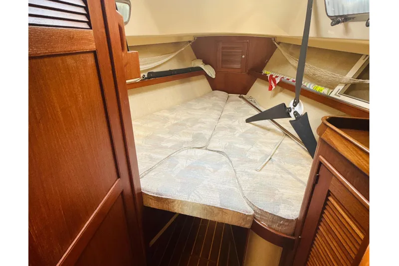 Slide: The Image of Interior view of 1995 Island Packet 37 sailboat with wooden door and cozy seating area. - 48