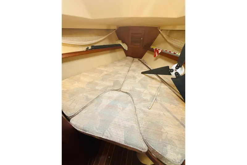 Slide: The Image of Interior view of 1995 Island Packet 37 sailboat cabin with wooden finish and cozy bed. - 49