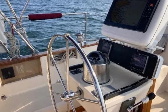 Slide: The Image of Cockpit of 1995 Island Packet 37 sailboat with navigation equipment and steering wheel. - 5
