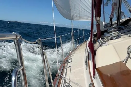 Slide: The Image of 1995 Island Packet 37 sailboat mast with Raymarine equipment on gravel surface. - 57