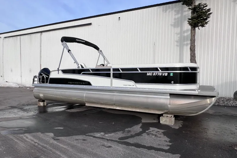 Slide: The Image of 2024 Princecraft Vectra 25 RL pontoon boat parked outside a warehouse. - 10
