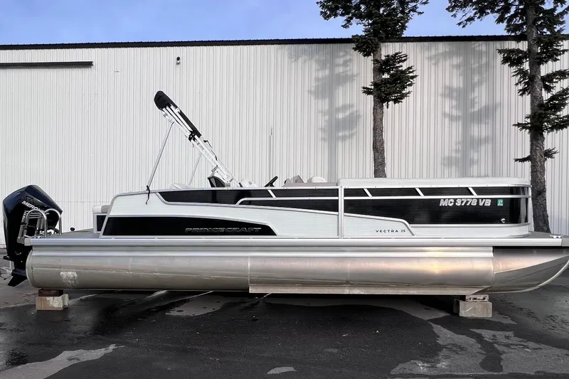 Slide: The Image of 2024 Princecraft Vectra 25 RL pontoon boat with sleek design, parked outdoors. - 11