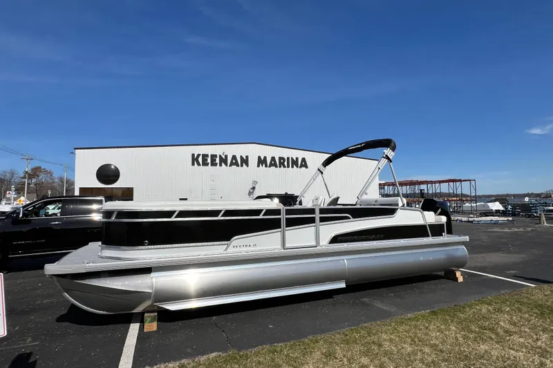 Slide: The Image of 2024 Princecraft Vectra 25 RL pontoon boat at Keenan Marina under clear blue sky. - 3