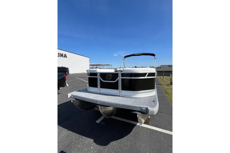 Slide: The Image of 2024 Princecraft Vectra 25 RL pontoon boat parked outdoors under clear blue sky. - 4