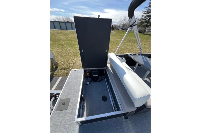 Slide: The Image of 2024 Princecraft Vectra 25 RL boat with open storage compartment, showcasing seating and deck. - 7