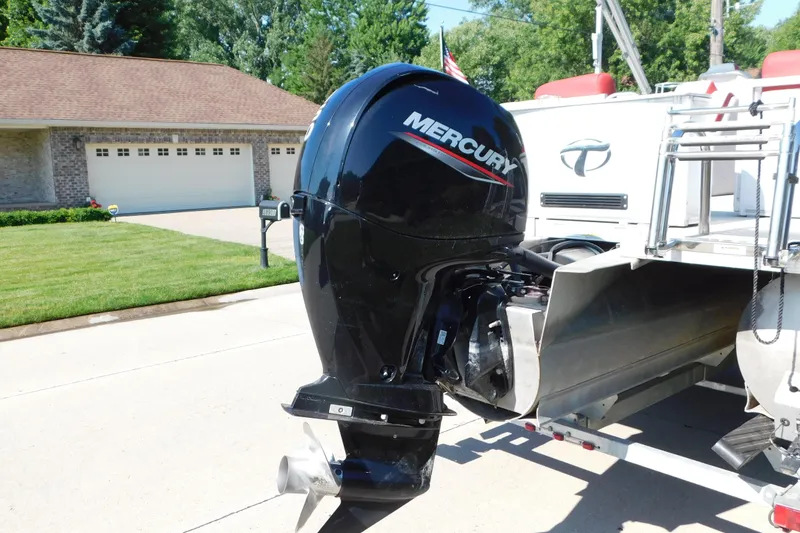 Slide: The Image of 2023 Tahoe Pontoon 2385 LTZ Quad Lounger with Mercury outboard motor in driveway. - 4