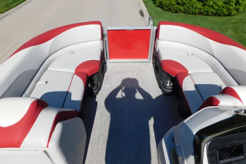 Slide: The Image of 2023 Tahoe Pontoon 2385 LTZ Quad Lounger with red and white seating, shadow on deck. - 30
