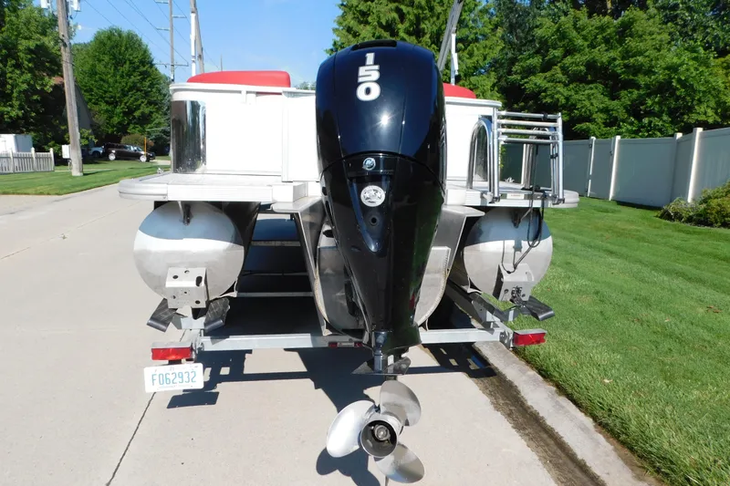 Slide: The Image of 2023 Tahoe Pontoon 2385 LTZ Quad Lounger with 150 HP engine on trailer. - 5