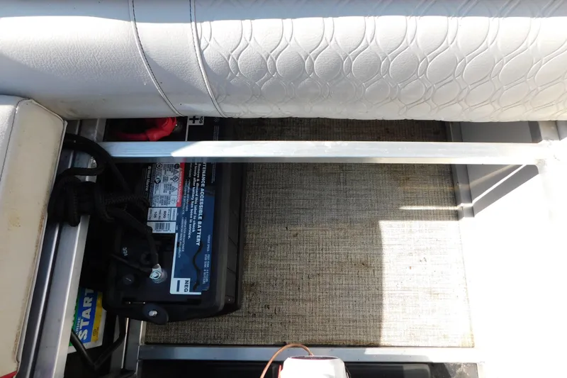 Slide: The Image of Battery compartment of 2023 Tahoe Pontoon 2385 LTZ Quad Lounger with textured seating. - 20