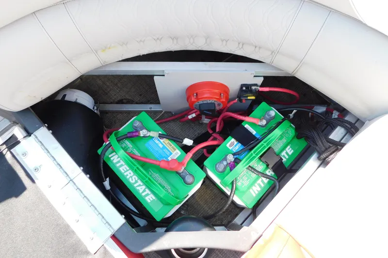 Slide: The Image of Battery compartment of 2023 Tahoe Pontoon 2385 LTZ Quad Lounger with Interstate batteries. - 18