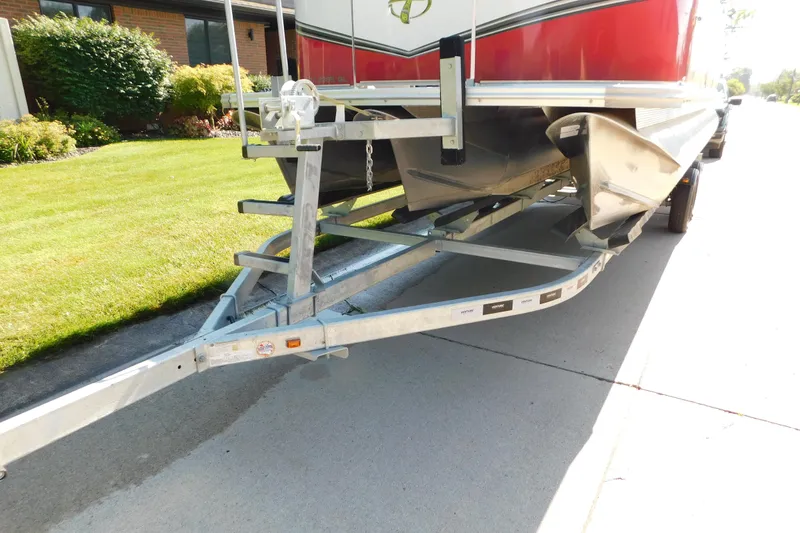 Slide: The Image of 2023 Tahoe Pontoon 2385 LTZ Quad Lounger on trailer, parked on residential street. - 55