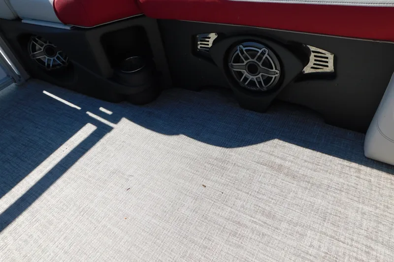 Slide: The Image of 2023 Tahoe Pontoon 2385 LTZ Quad Lounger interior with speaker and red seating. - 39