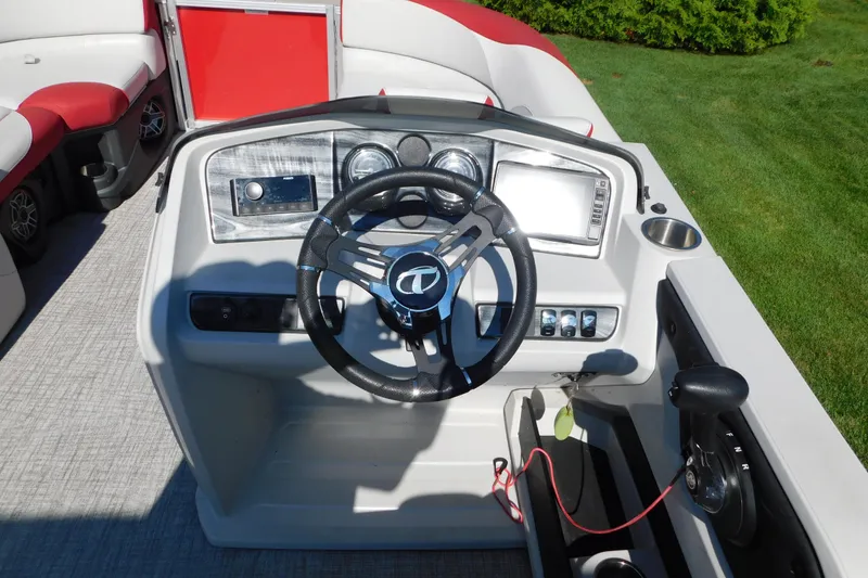 Slide: The Image of 2023 Tahoe Pontoon 2385 LTZ Quad Lounger dashboard with steering wheel and controls. - 26