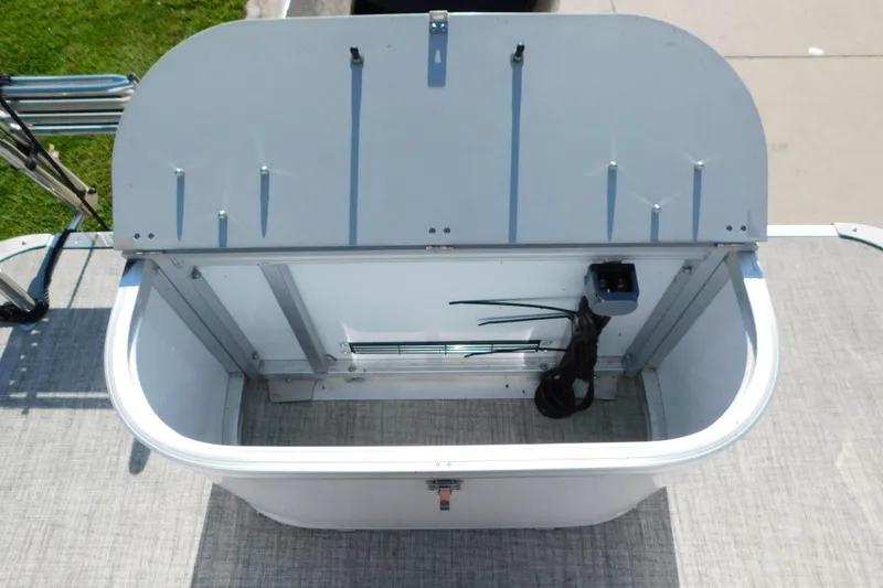 Slide: The Image of Open storage compartment on 2023 Tahoe Pontoon 2385 LTZ Quad Lounger boat. - 10