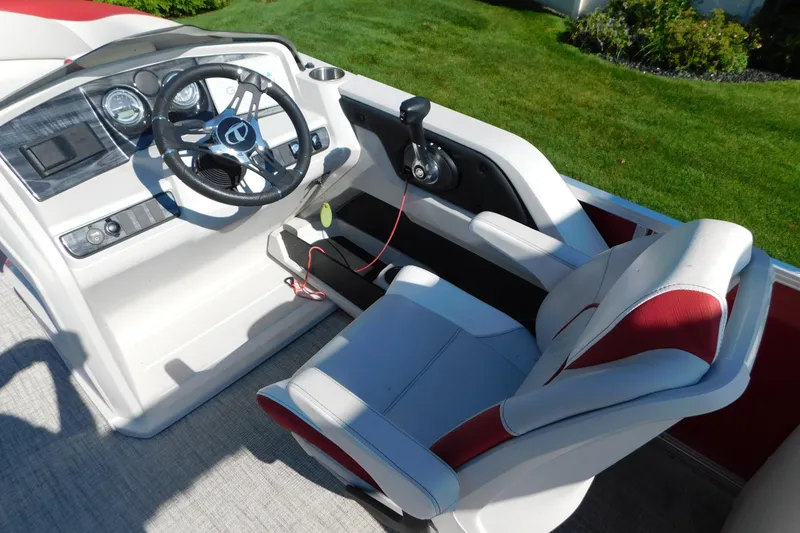 Slide: The Image of 2023 Tahoe Pontoon 2385 LTZ Quad Lounger helm with steering wheel and captain's chair. - 22