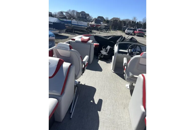 Slide: The Image of 2023 Tahoe Pontoon 2385 Cascade Quad Lounger interior with red and white seating. - 6