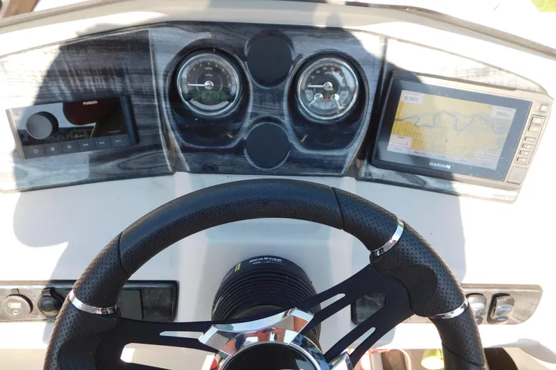 Slide: The Image of Steering console of 2023 Tahoe Pontoon 2385 LTZ Quad Lounger with navigation and control panel. - 27