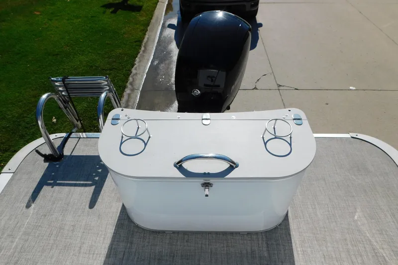 Slide: The Image of 2023 Tahoe Pontoon 2385 LTZ Quad Lounger with motor and ladder, docked on pavement. - 46