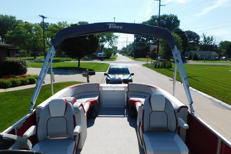 Slide: The Image of 2023 Tahoe Pontoon 2385 LTZ Quad Lounger on a sunny street, showcasing spacious seating. - 45