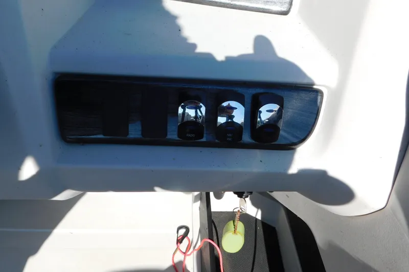Slide: The Image of Control panel of 2023 Tahoe Pontoon 2385 LTZ Quad Lounger with switches and keychain. - 42