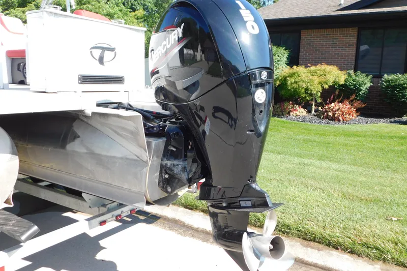 Slide: The Image of 2023 Tahoe Pontoon 2385 LTZ Quad Lounger with Mercury outboard motor, parked on a trailer. - 6