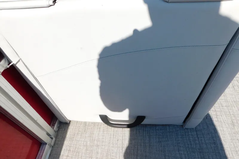 Slide: The Image of 2023 Tahoe Pontoon 2385 LTZ Quad Lounger interior detail with shadow and handle. - 50