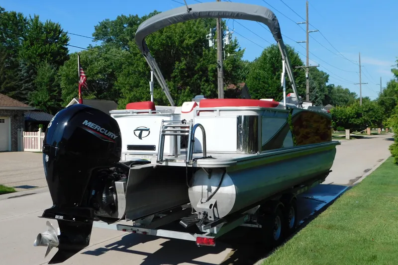 Slide: The Image of 2023 Tahoe Pontoon 2385 LTZ Quad Lounger on trailer, featuring Mercury outboard motor. - 3