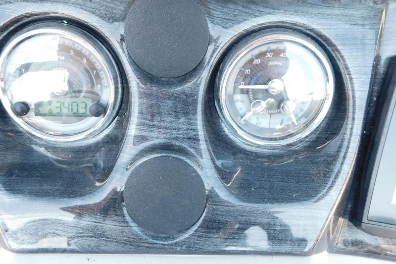 Slide: The Image of Dashboard of 2023 Tahoe Pontoon 2385 LTZ Quad Lounger with speedometer and RPM gauges. - 28