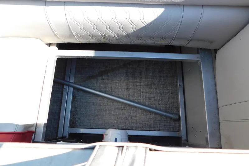 Slide: The Image of Storage compartment of 2023 Tahoe Pontoon 2385 LTZ Quad Lounger, featuring metal frame and upholstery. - 32