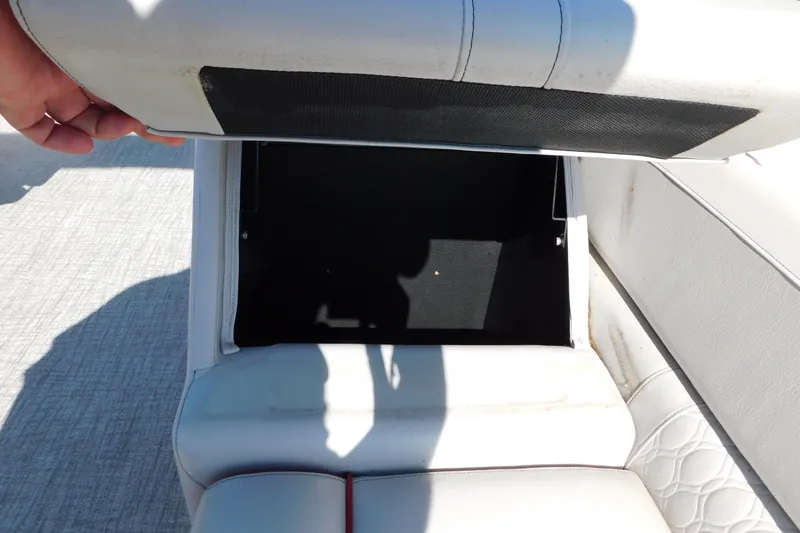 Slide: The Image of Open storage compartment in 2023 Tahoe Pontoon 2385 LTZ Quad Lounger boat seat. - 16